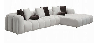Channel tufted Right facing sectional upholstered in white fabric waccent pillows