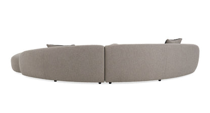 Glam Curved Sectional Sofa upholstered in taupe fabric with black and taupe accent pillows