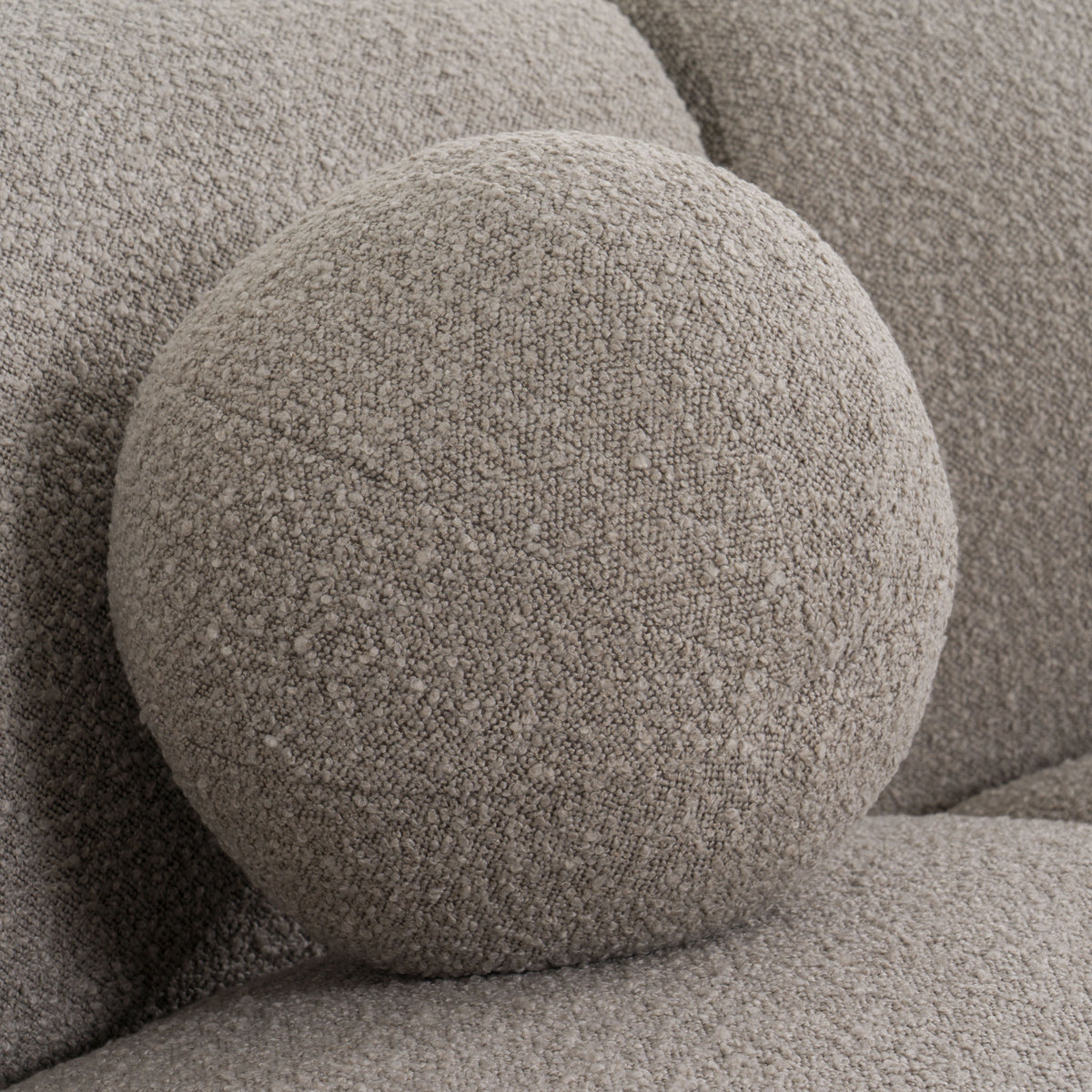 Glam Curved Sectional Sofa upholstered in taupe fabric with black and taupe accent pillows